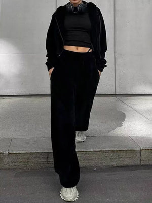 Black cropped zip hoodie and wide leg pants set with a black crop top.