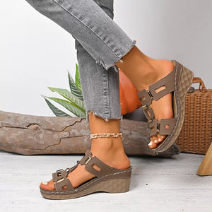 Brown open-toe wedge sandals with decorative gold accents and contrast stitching.