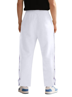 White men's track pants with snap buttons down the sides.