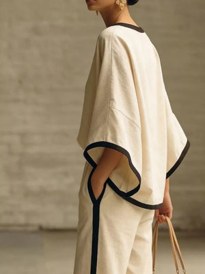 Apricot two-piece set with contrast trim, boat neck top and wide sleeves.