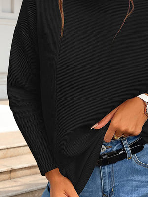 Black ribbed turtleneck sweater with long sleeves and a relaxed fit.