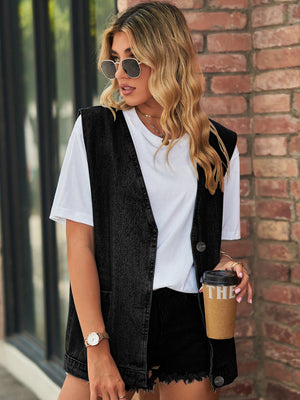 Black oversized denim vest with patch pockets and button front, worn over a white tee.
