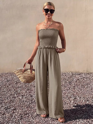 Smocked strapless olive green wide-leg romper with frill detail and wide legs.