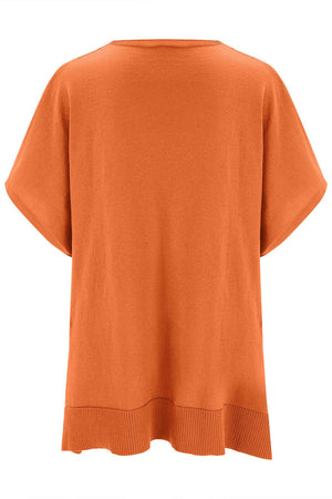 Relaxed V-neck knit poncho top in pumpkin with short sleeves and ribbed hem.