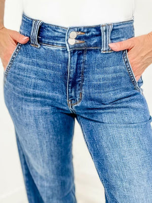 Medium wash denim jeans with wide leg and utility pockets.