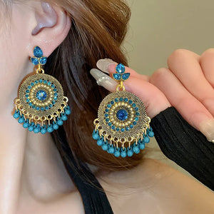 Cerulean beaded medallion and pearl drop earrings with gold alloy accents.