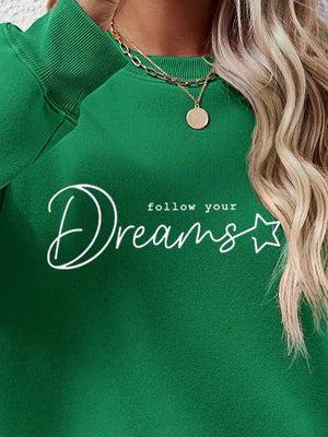Green oversized sweatshirt with white script graphic and star detail.