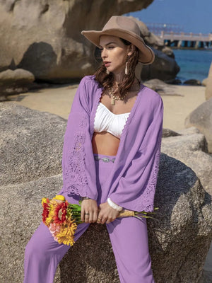 Purple open front set with lace trim on sleeves and neckline, worn with white bralette and matching pants.