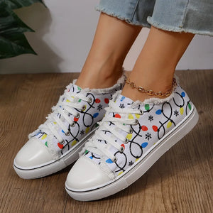 White canvas sneakers with string light pattern and fringe trim.