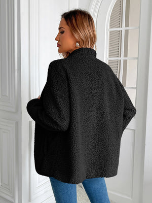 Black teddy fleece jacket with patch pockets, mock neck, and long sleeves.