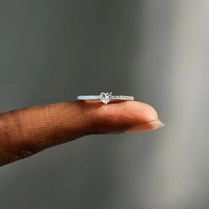 Sterling silver ring with pave band and white enamel, featuring a heart-shaped center stone.