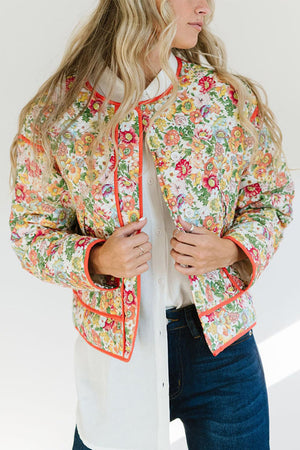 Floral quilted jacket with contrast piping and a stand-up collar.