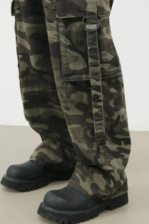 Wide-leg camo cargo pants with belt detail and D-ring accent.