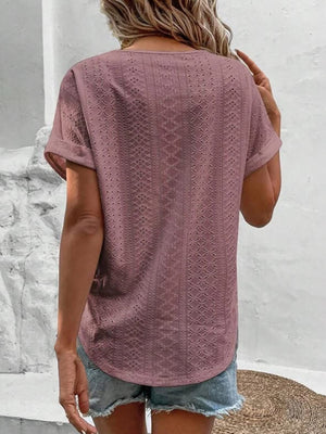 Eyelet V-neck tunic top in pink purple with short sleeves and a textured pattern.