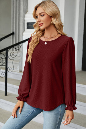 Burgundy textured puff sleeve blouse with ruffled cuffs.