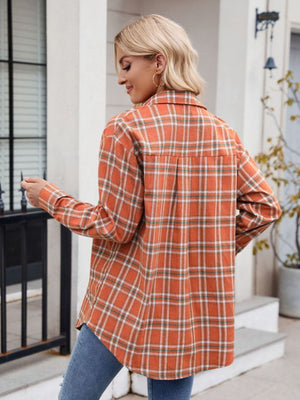 Orange plaid overshirt with buttoned front and patch pockets, long sleeves.