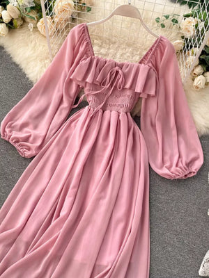 Pink ruffled square neck maternity dress with balloon sleeves and smocked bodice.