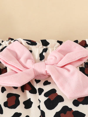 Baby bodysuit with pink bow detail and leopard print.
