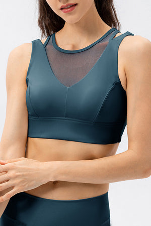 Mesh inset performance bra top in dark blue with V-neck and strappy detail