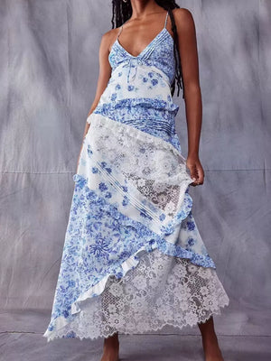 Blue floral lace maxi dress with asymmetrical ruffled hem and tie-front bodice.