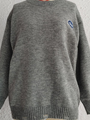 Dark gray acrylic knit sweater with embroidered blue oval detail and distressed hem.