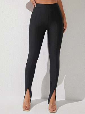 Black cotton leggings with center seam and split hem detail