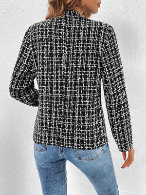 Black and white textured tweed blazer with a plaid pattern, open front, and long sleeves.