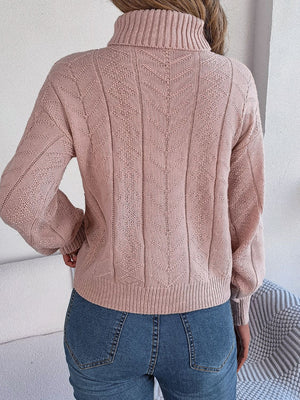 Dusty Pink cable knit turtleneck sweater with drop shoulder and textured pattern.