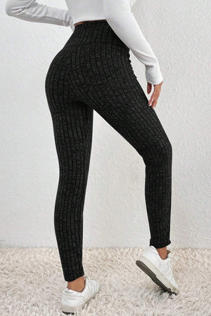 Textured knit leggings in black with a ribbed pattern and high waist.