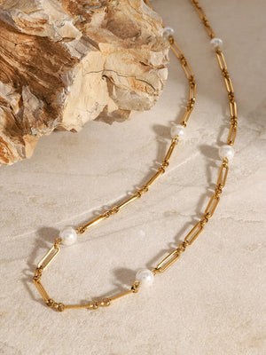 Gold chain necklace with pearl accents and elongated links