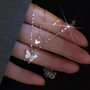 Elegant double-layer necklace with sparkling butterfly charms in white gold.