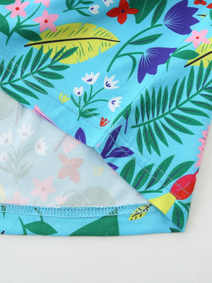 Toddler dress with blue tropical floral print, cotton, with visible stitching details.