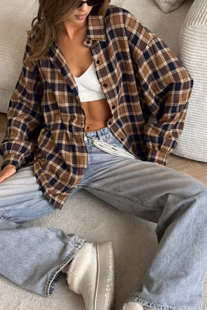 Oversized brown plaid button-up shirt jacket with buttoned cuffs and collar.