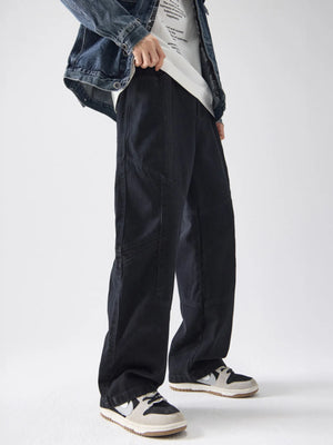 Black cotton wide-leg trousers with panel details and a relaxed fit.