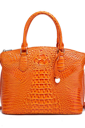 Pumpkin orange crocodile embossed satchel with top handle and decorative tassel.