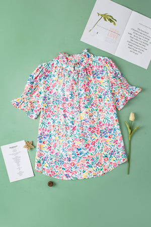Floral ruffle collar puff sleeve blouse with smocked cuffs and a button-up neckline.