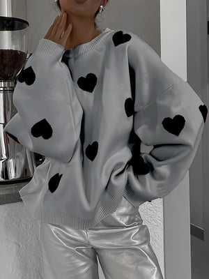 Gray oversized knit crewneck sweater with black heart pattern and drop sleeves.