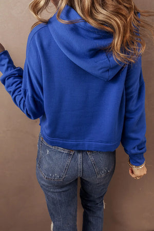 Cobalt cropped hoodie with hood and long sleeves, shown from the back.