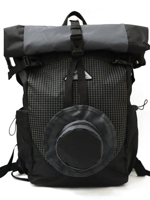 Black nylon roll-top backpack with grid pattern and circular front pocket.