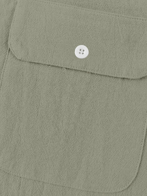 Military green cotton henley shirt with button-flap chest pocket detail.