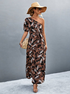Black tropical print one-shoulder maxi dress with balloon sleeves and tie waist.