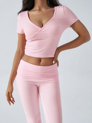 Blush pink loungewear set with a ruched waistband and V-neck wrap top.