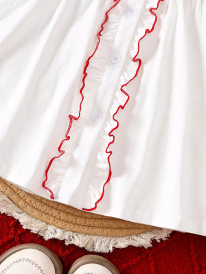 White cotton baby dress with red embroidered ruffles and buttons.