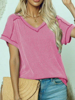 Pink ribbed V-neck tee with contrast stitching and short sleeves.