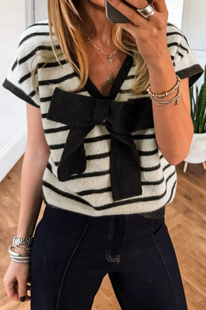 Chic black and white striped knit top with a large black bow detail and short sleeves.