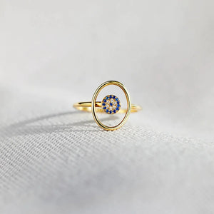 Gold oval ring with blue and clear crystal evil eye detail