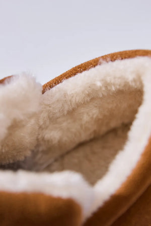 Caramel suede house booties with plush shearling lining detail.