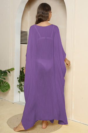 Purple oversized caftan cover-up with side slits, sheer fabric, v-neck, long flowy sleeves.