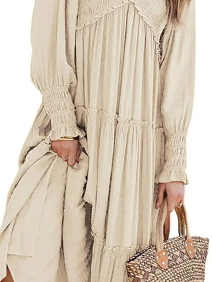 Apricot smocked v-neck tiered maxi dress with ruffled details and smocked cuffs.