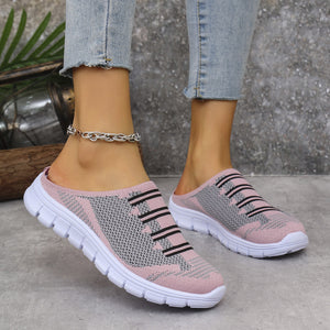 Pink and gray knit slip-on sneakers with black stripe detail and white soles.